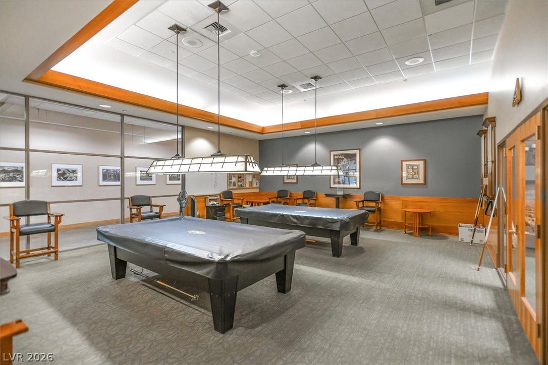 468 Bonnie Brook Place, Henderson, NV 89012 A refined recreation space features two billiards tables and ample seating under suspended lighting.
