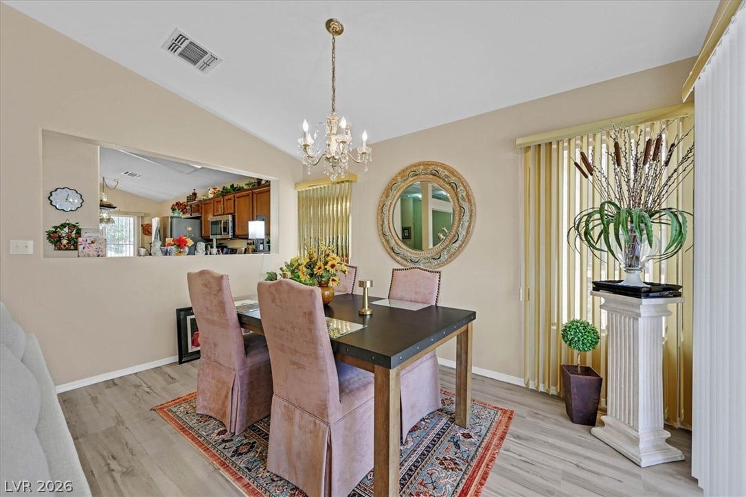 468 Bonnie Brook Place, Henderson, NV 89012 The elegant dining room offers a seamless view into the adjacent kitchen.