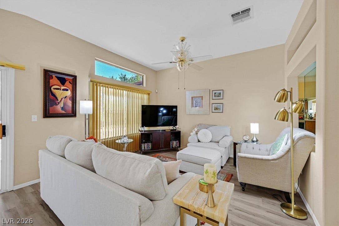 468 Bonnie Brook Place, Henderson, NV 89012 Natural light streams into this living area, featuring high ceilings and sleek flooring.