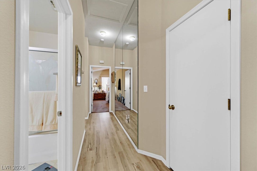 468 Bonnie Brook Place, Henderson, NV 89012 A well-lit corridor with durable plank flooring leads to various living spaces.