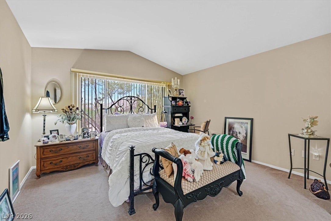 468 Bonnie Brook Place, Henderson, NV 89012 An airy bedroom with vaulted ceilings offers a spacious, naturally illuminated retreat.