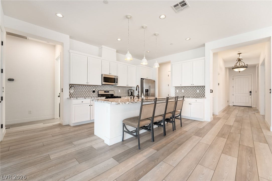 330 Meadow Brush Place, Henderson, NV 89011 Culinary creations come alive in this kitchen, featuring an inviting island with a breakfast bar and modern appliances.