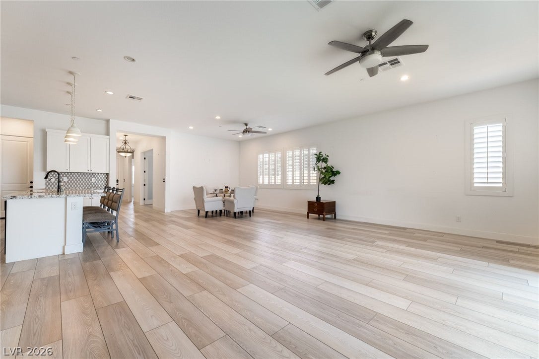 330 Meadow Brush Place, Henderson, NV 89011 An open floorplan living space flows seamlessly from a modern kitchen into a sun-filled area.