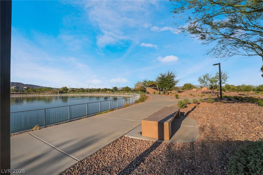 330 Meadow Brush Place, Henderson, NV 89011 A tranquil waterside path invites leisurely strolls with captivating distant mountain vistas.