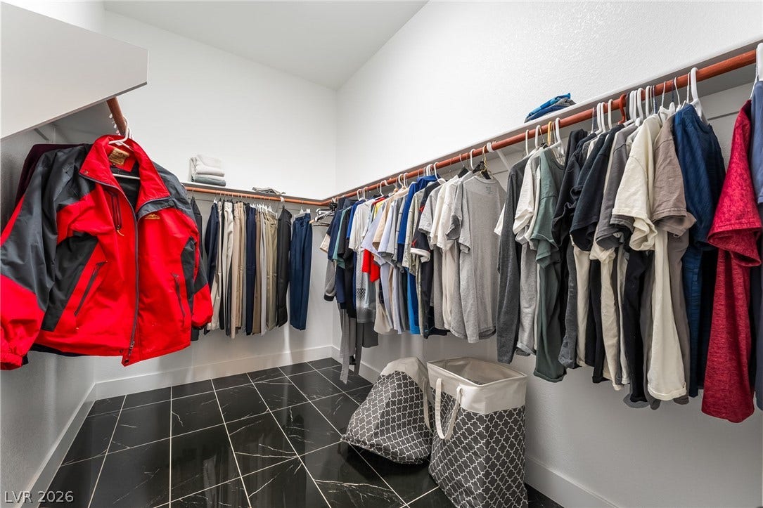 330 Meadow Brush Place, Henderson, NV 89011 A well-organized walk-in closet features ample hanging space and sleek tile flooring.