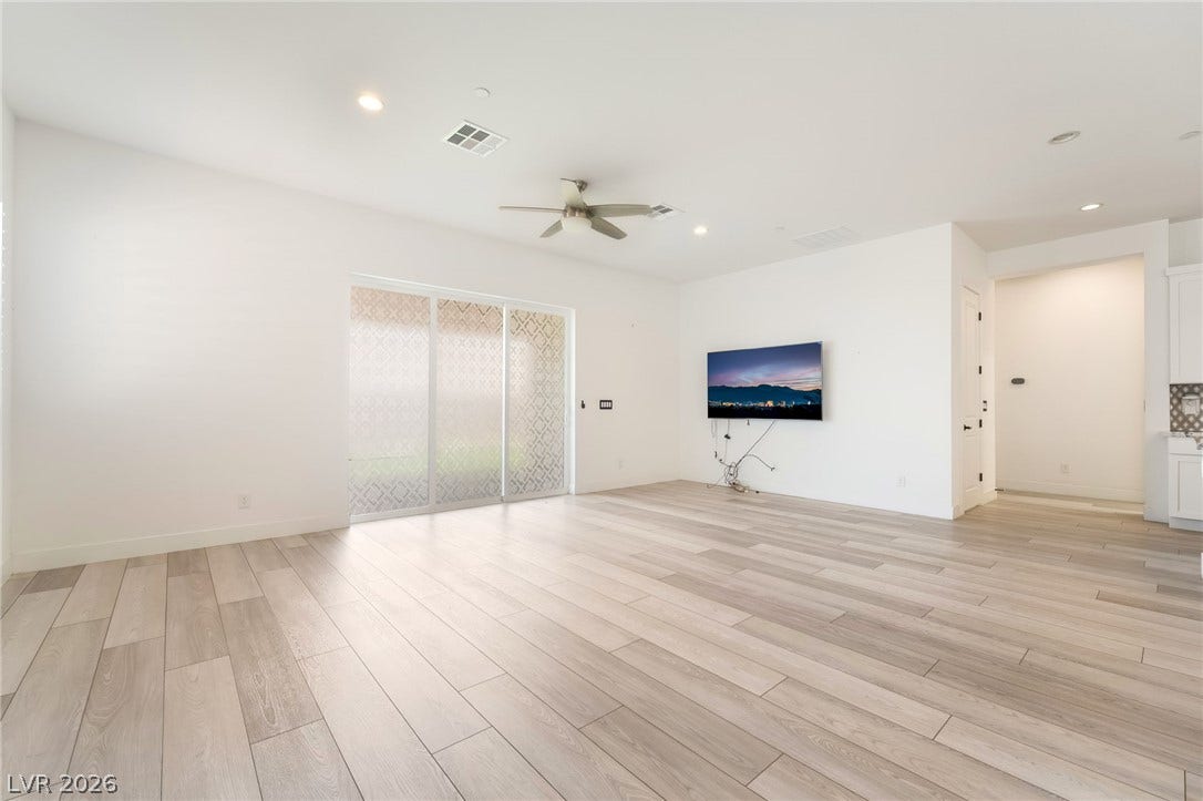 330 Meadow Brush Place, Henderson, NV 89011 Sliding glass doors offer ample light, complementing the wood flooring and modern recessed lighting.