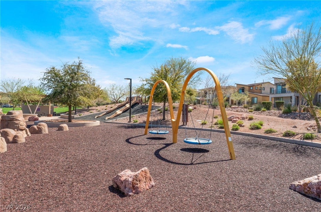330 Meadow Brush Place, Henderson, NV 89011 A vibrant community play area offers swings and slides for endless outdoor fun.