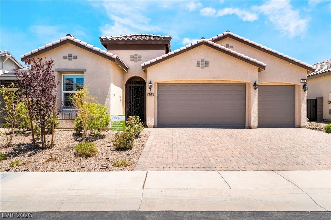 330 Meadow Brush Place, Henderson, NV 89011 A well-maintained stucco home with a double garage and charming desert landscaping.