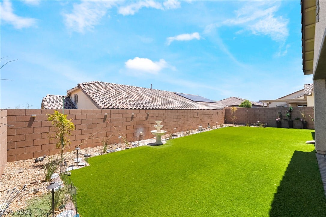 330 Meadow Brush Place, Henderson, NV 89011 Green turf and a tiered fountain create a refreshing backyard sanctuary.