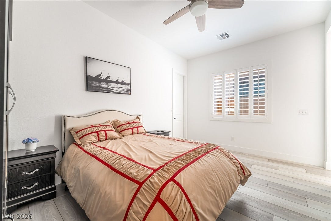 330 Meadow Brush Place, Henderson, NV 89011 Comfortable sleeping space featuring hardwood flooring and a ceiling fan for year-round ease.