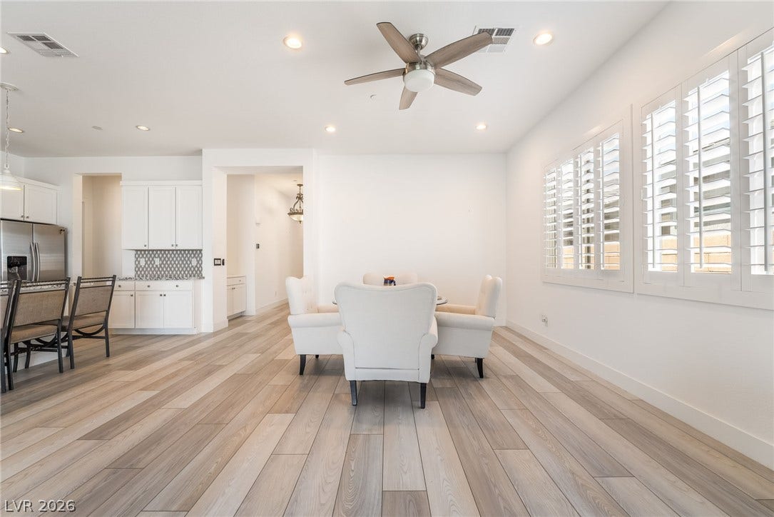 330 Meadow Brush Place, Henderson, NV 89011 Well-lit living space with light wood flooring and a modern ceiling fan.