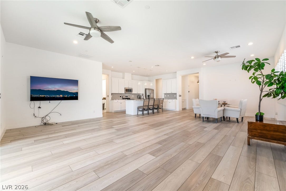 330 Meadow Brush Place, Henderson, NV 89011 A luminous open-concept great room connects kitchen and living areas with light hardwood-style flooring.