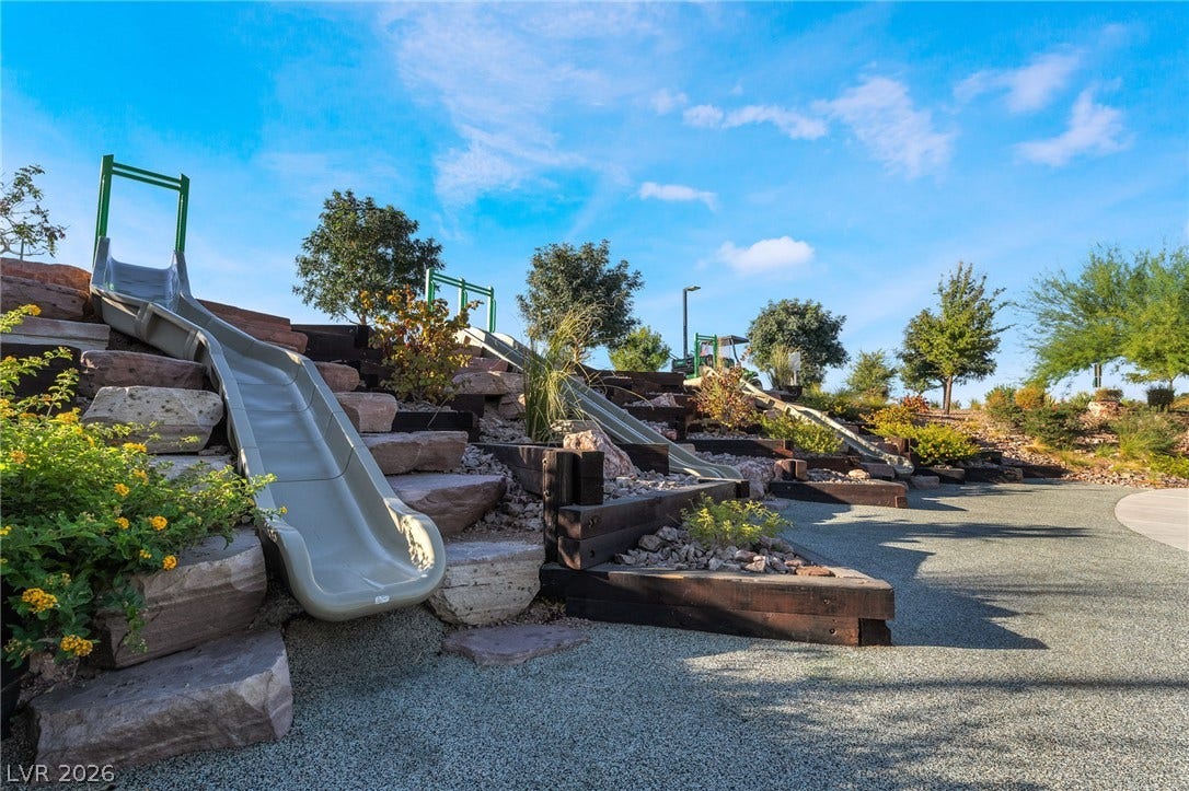 330 Meadow Brush Place, Henderson, NV 89011 Multiple slides cascade down a terraced landscape, offering a playful outdoor amenity.