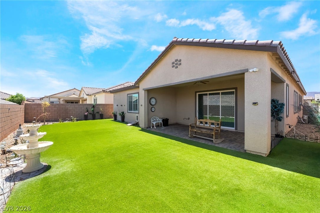 330 Meadow Brush Place, Henderson, NV 89011 A well-maintained yard features a covered patio and a charming water fountain.
