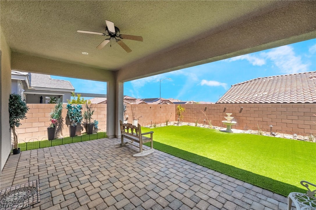 330 Meadow Brush Place, Henderson, NV 89011 Enjoy outdoor living on this covered patio, featuring paver flooring and an inviting expanse of green space.