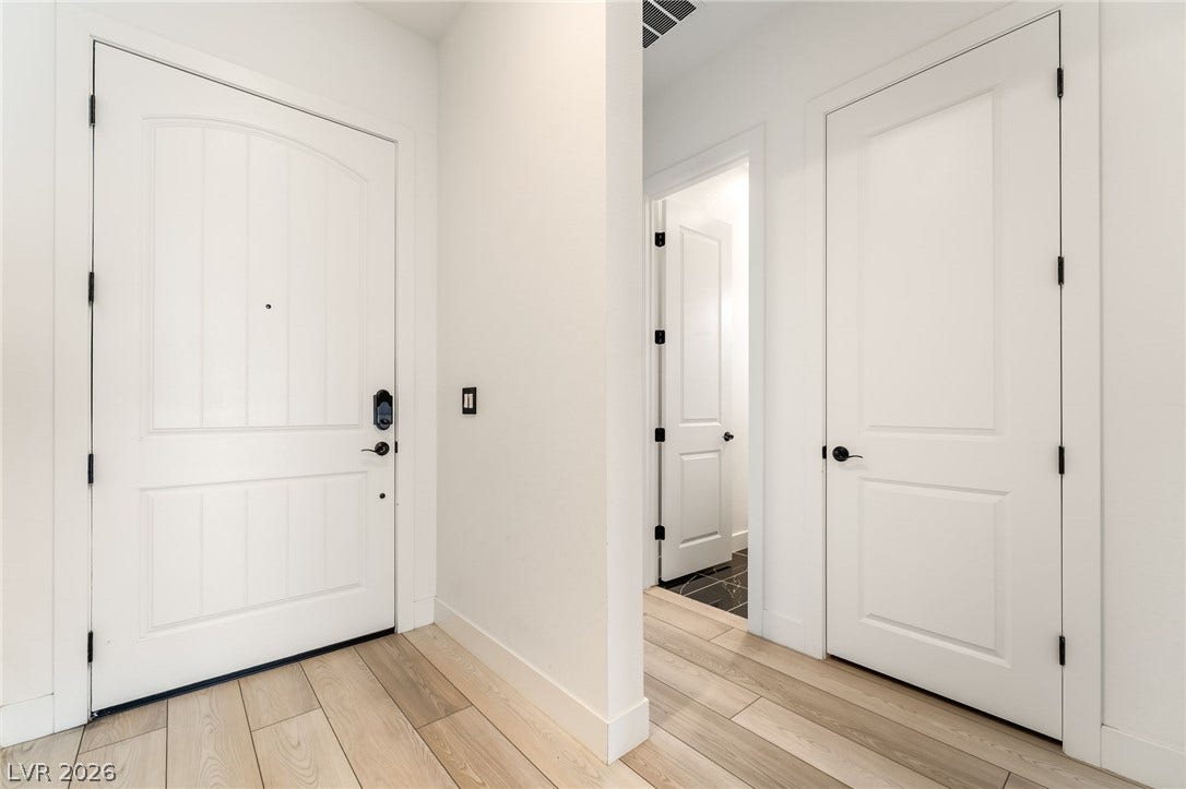330 Meadow Brush Place, Henderson, NV 89011 Welcoming entry with a robust door and modern light wood flooring leading into the home.