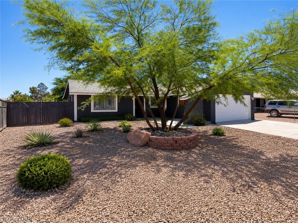A drought-tolerant landscape complements this homes modern facade and integrated garage.