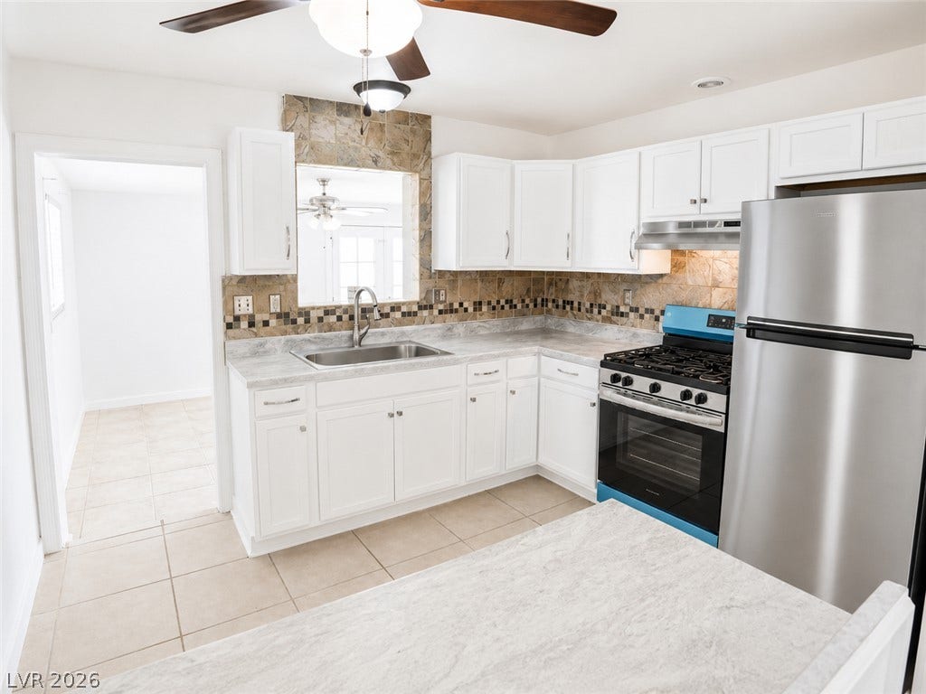 A well-appointed kitchen showcasing white cabinetry and practical appliances for daily culinary needs.