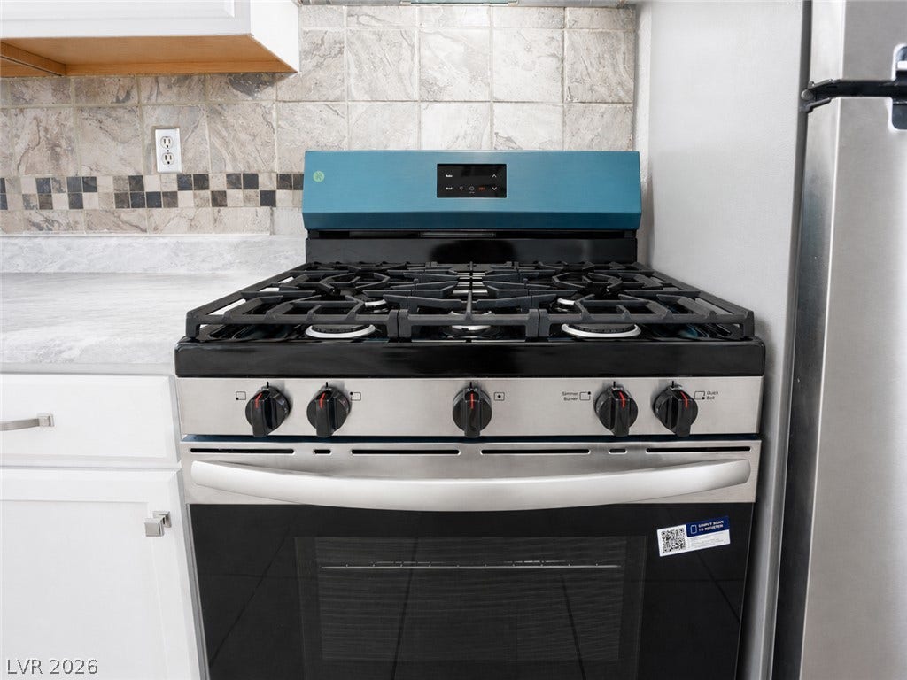 Sleek stainless steel range and oven elevate this kitchens culinary appeal.
