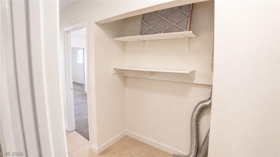 Ample shelving in this dedicated laundry space offers practical storage solutions.