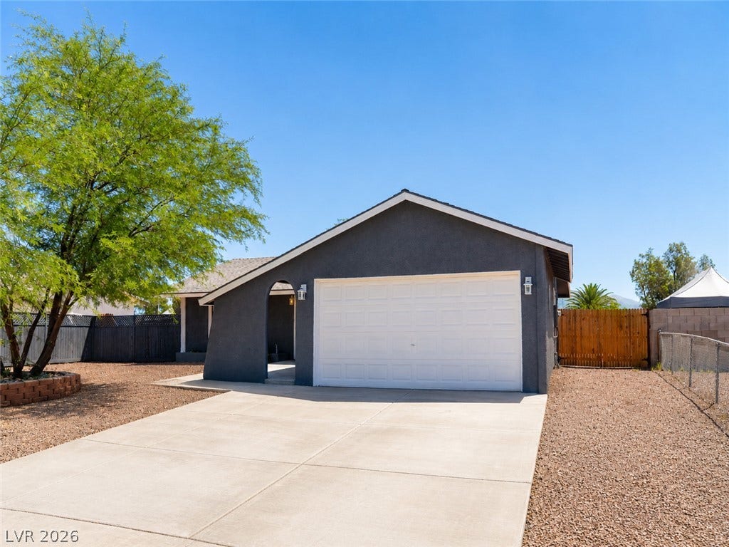 A well-maintained facade with a private garage offers comfortable living.