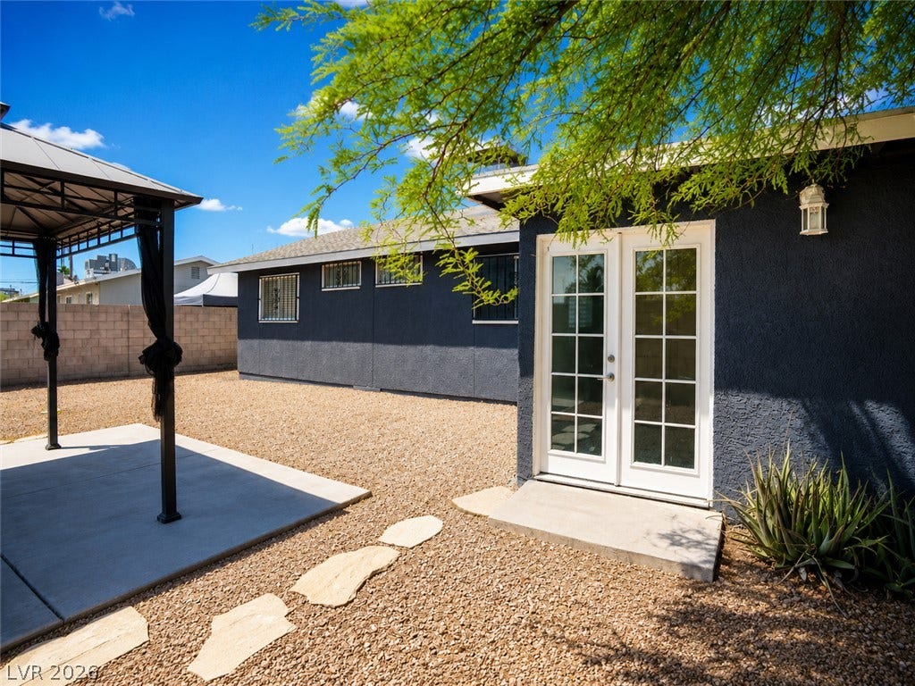 A spacious backyard retreat offers a shaded gazebo and easy access to the home.
