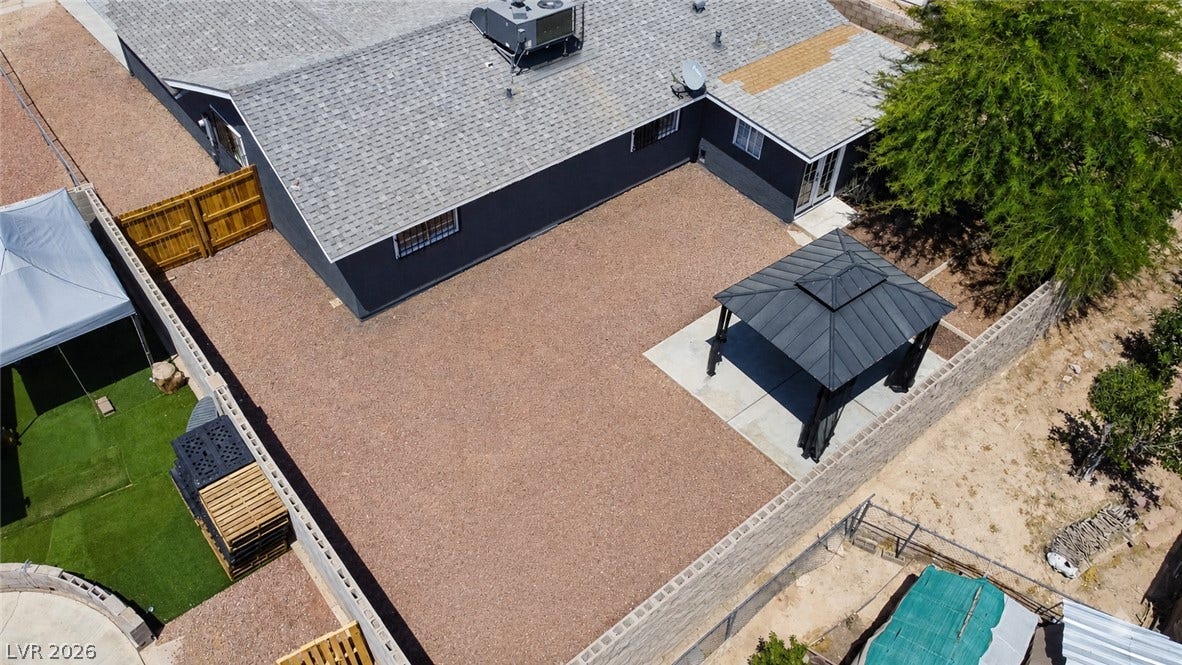 A spacious backyard with a charming gazebo offers an ideal setting for outdoor gatherings.
