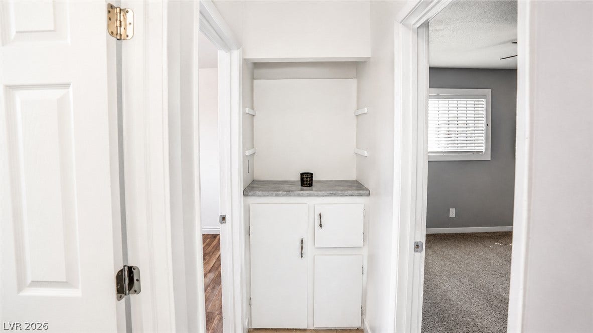 A clever built-in cabinet with storage below offers convenient organization.