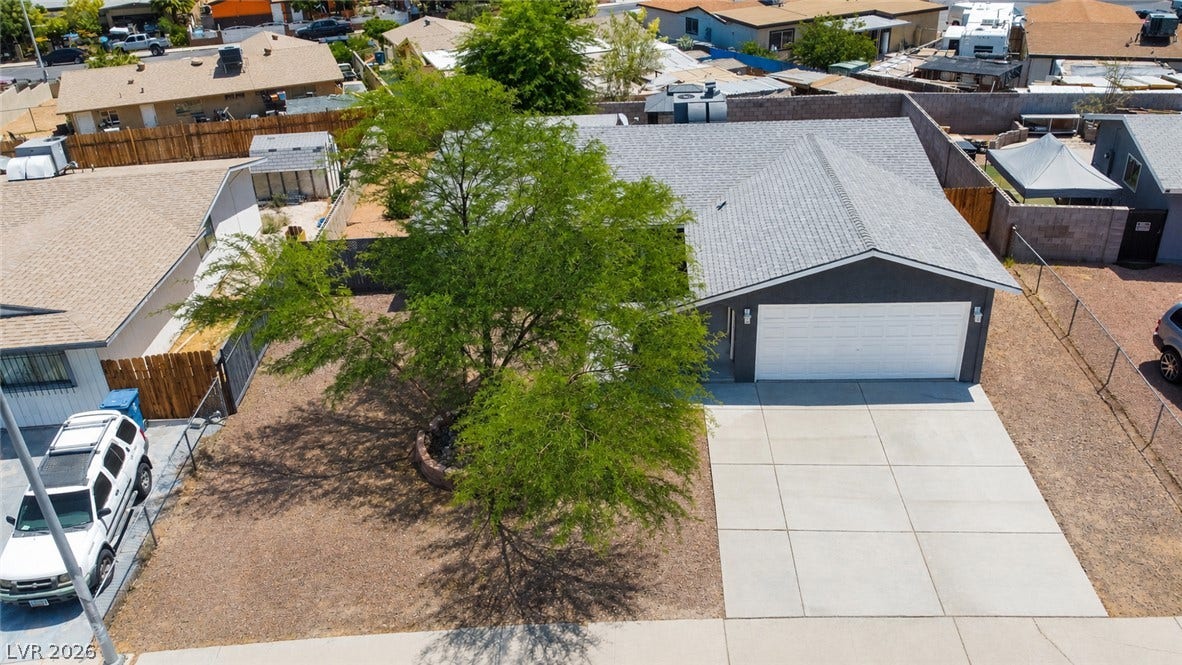 A well-maintained concrete driveway leads to a pristine garage with ample curb appeal.