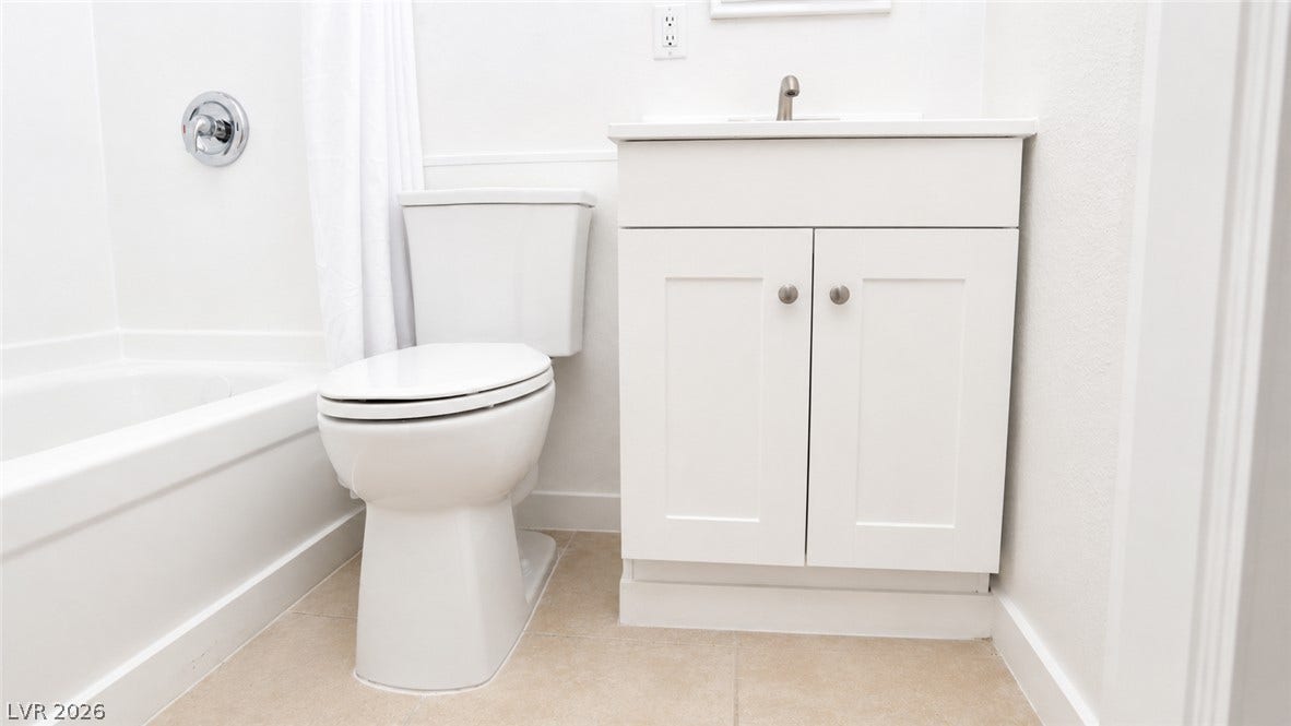 A well-appointed bath with a classic white vanity and modern fixtures.