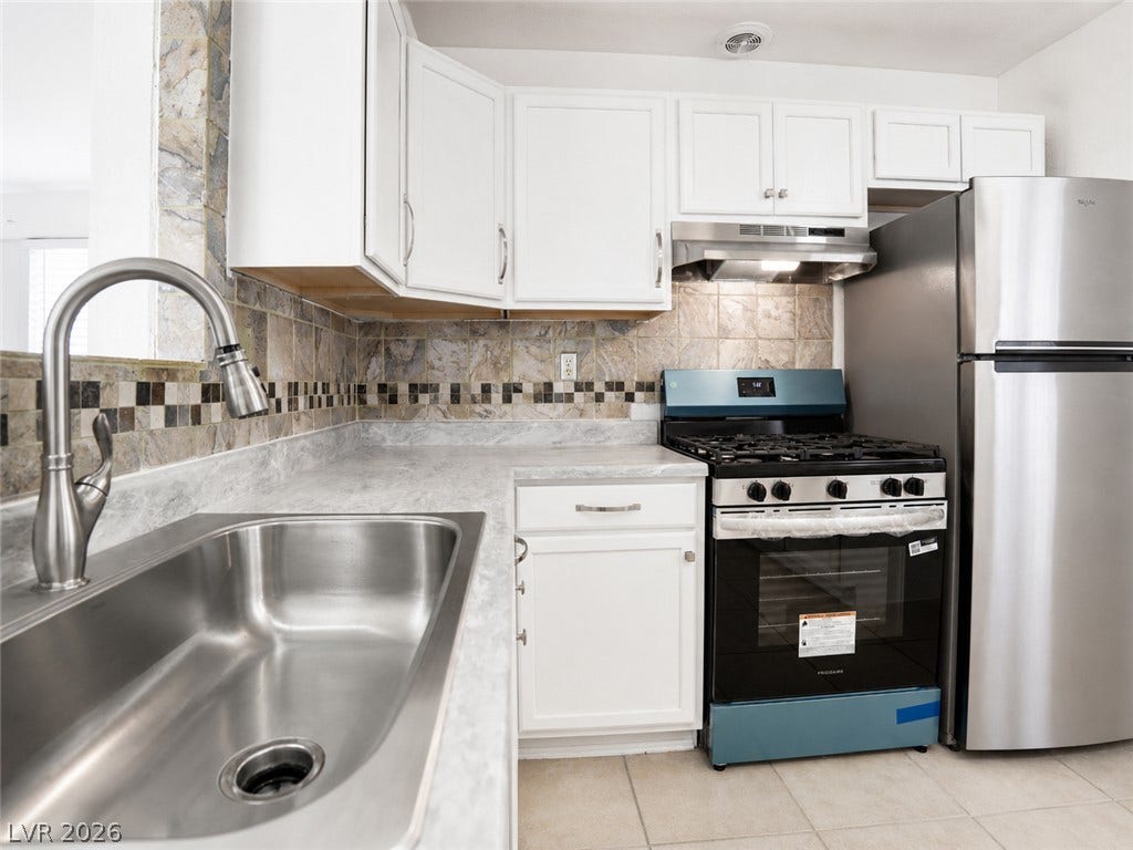 This kitchen showcases ample cabinet storage and modern appliances, creating a highly functional culinary space.