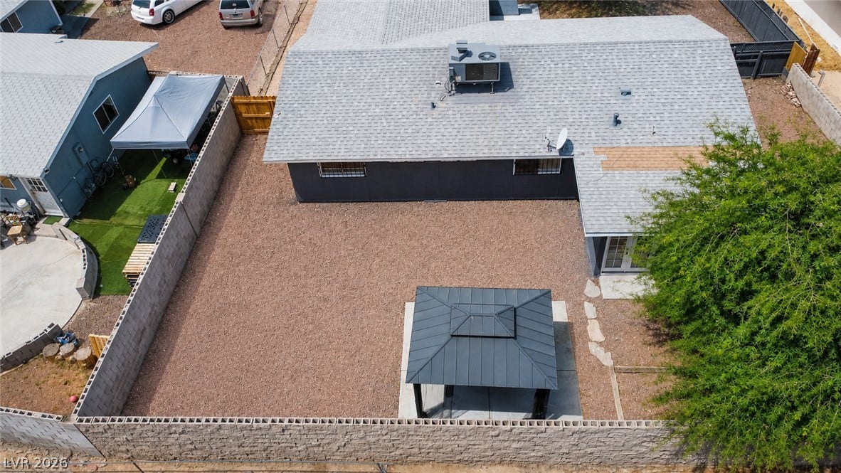 A private, low-maintenance backyard retreat featuring a stylish gazebo and decorative rock landscaping.
