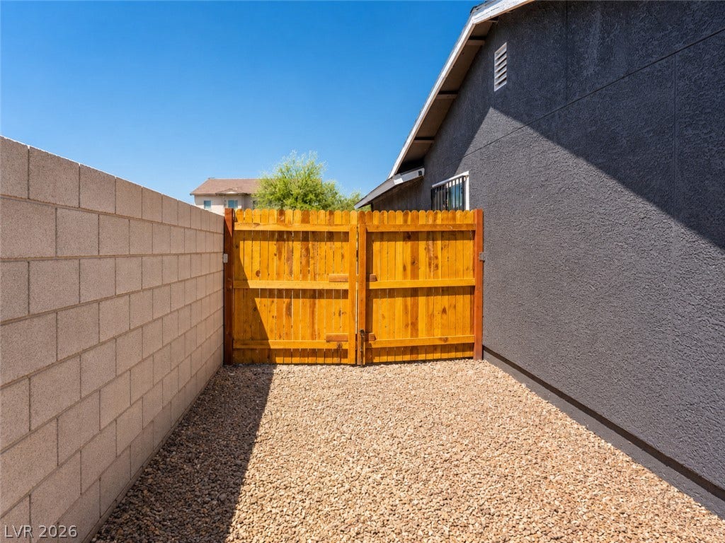 Secure yard access with a sturdy wood fence, alongside a durable concrete block wall.