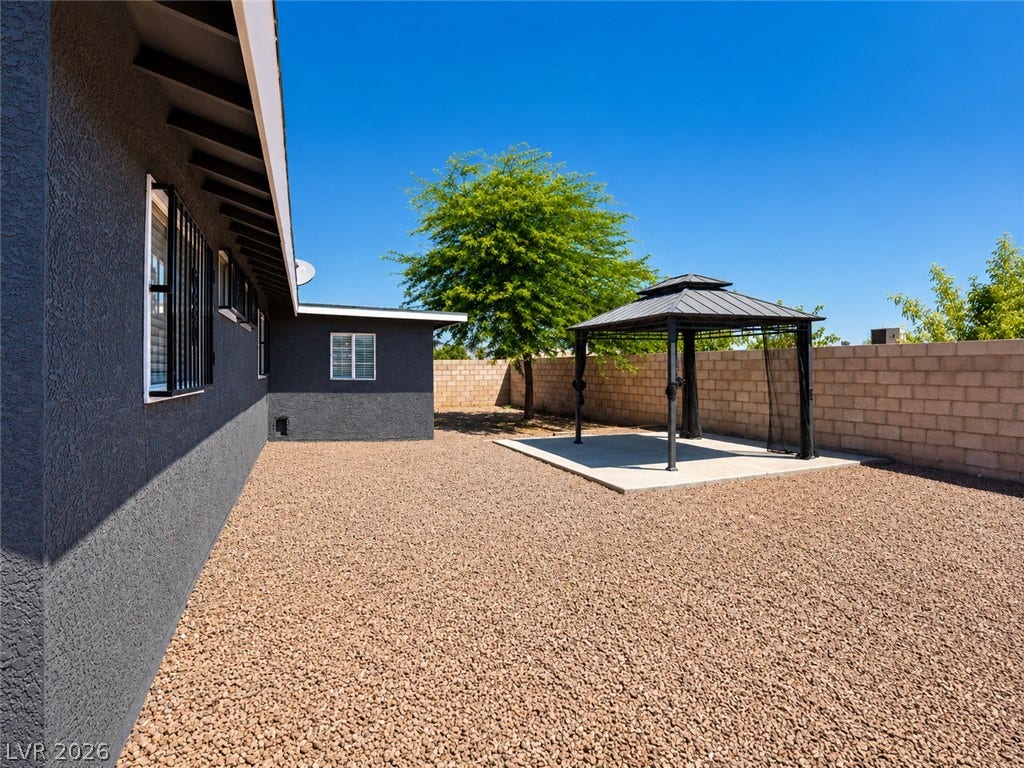 A private backyard oasis with a charming gazebo provides a peaceful retreat.