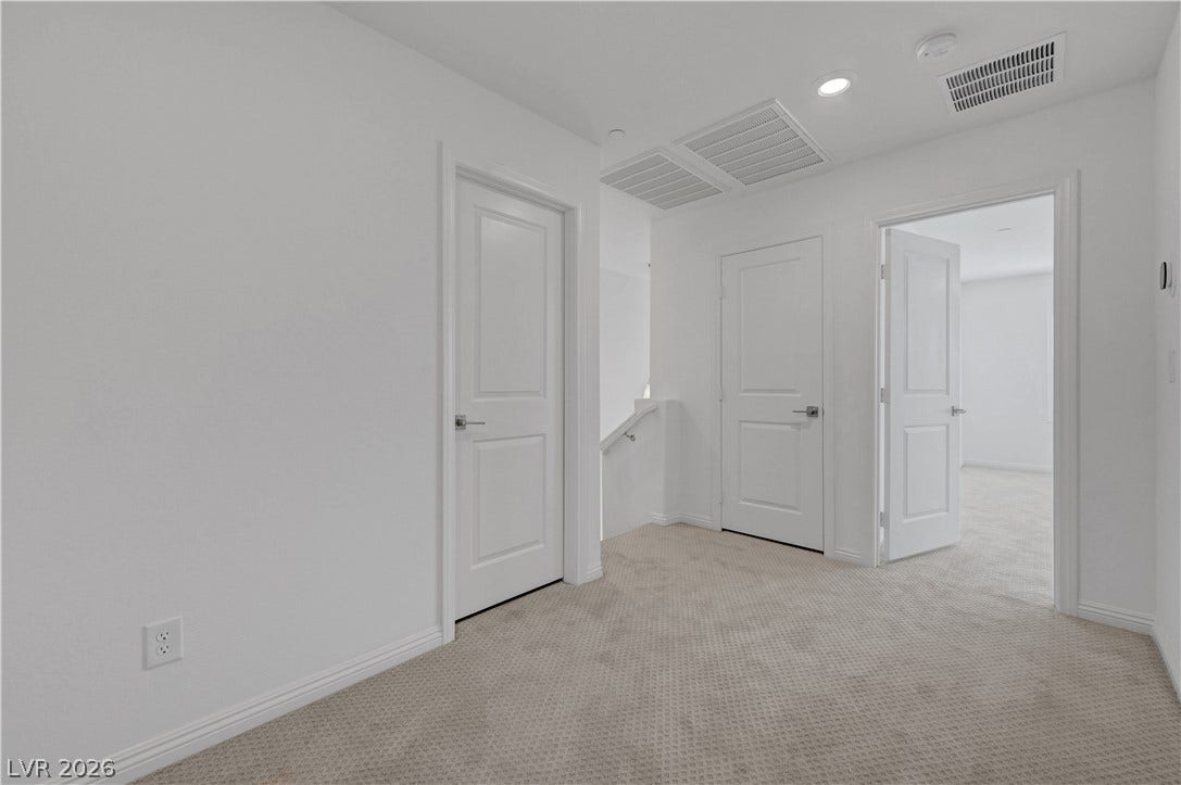 A well-lit landing provides access to several rooms, creating a practical and inviting transition space.
