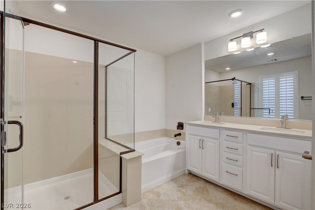 A well-appointed bathroom offers both a spacious shower and a soaking tub for ultimate relaxation.