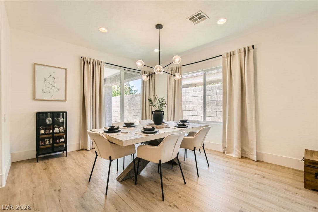 2724 Mintlaw Avenue, Henderson, NV 89044 A well-lit dining area featuring rich hardwood flooring and a stylish modern chandelier.