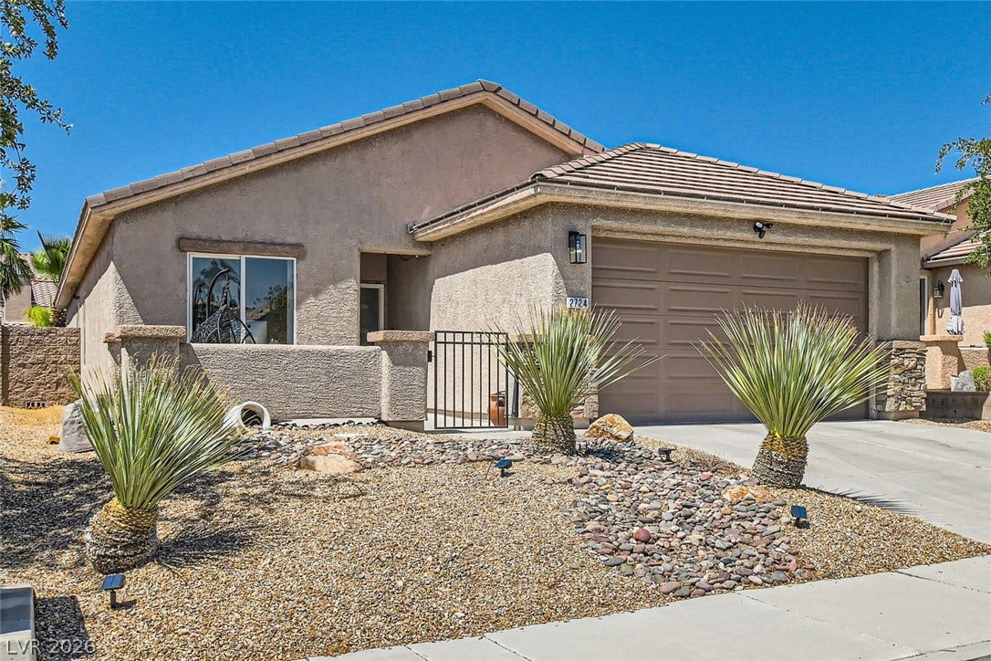 2724 Mintlaw Avenue, Henderson, NV 89044 A well-maintained stucco home with a two-car garage and desert-friendly landscaping.