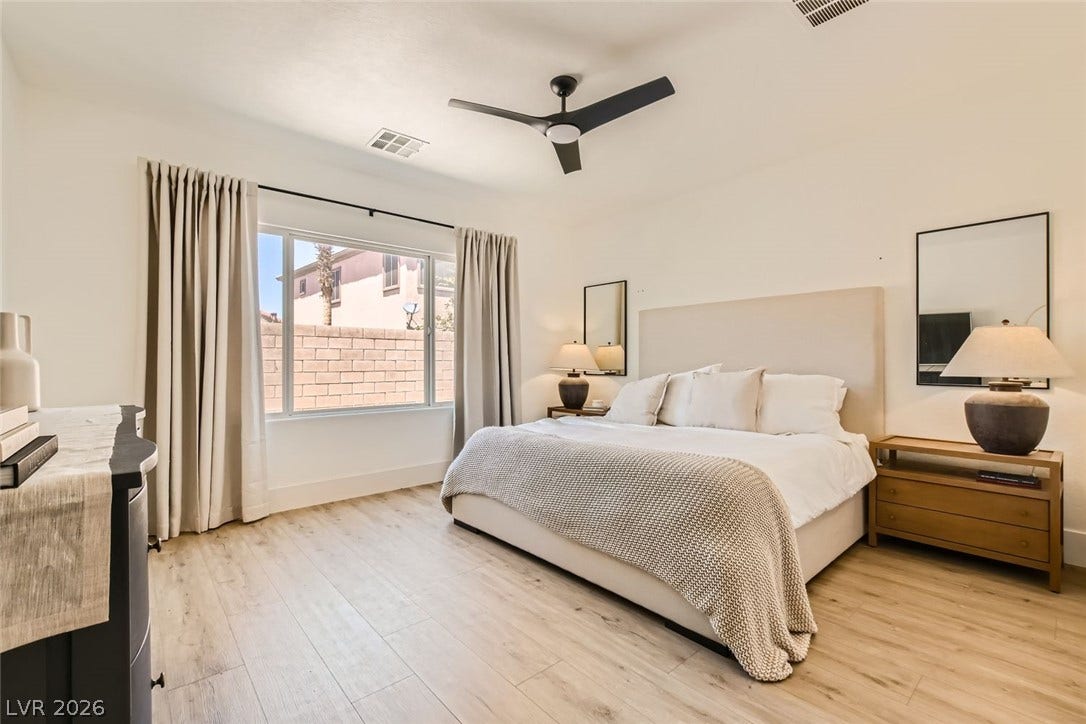 2724 Mintlaw Avenue, Henderson, NV 89044 Natural light illuminates this bedroom, offering light wood flooring and a refreshing ceiling fan.
