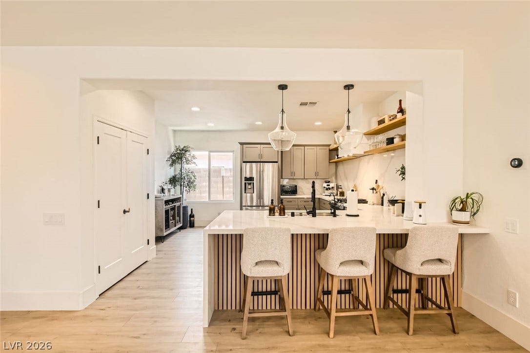 2724 Mintlaw Avenue, Henderson, NV 89044 A contemporary kitchen features an inviting breakfast bar with sleek pendant lighting.