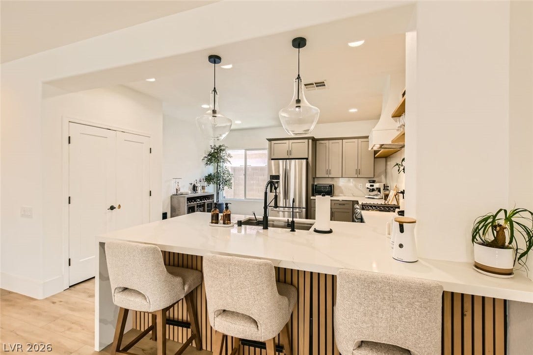 2724 Mintlaw Avenue, Henderson, NV 89044 Culinary excellence awaits in this well-appointed kitchen, featuring a spacious island and gleaming stainless steel appliances.