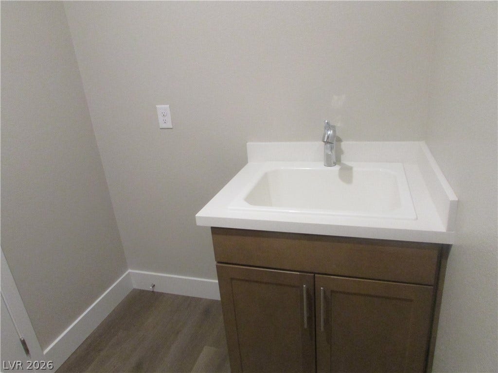 988 Gentle Swan, Henderson, NV 89011 A sleek utility sink provides practical functionality within this well-appointed laundry area. Laundry room has space for the extra Fridge! Super handy! Photo is of actual home.