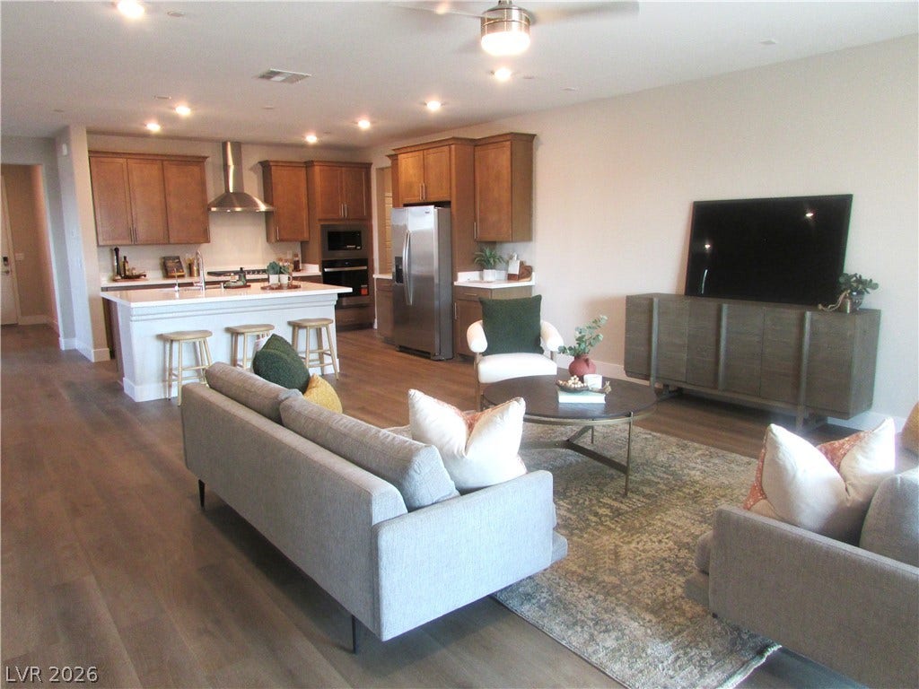 988 Gentle Swan, Henderson, NV 89011 An inviting open-concept space connects a well-appointed kitchen to a comfortable living area, perfect for daily life and entertaining.