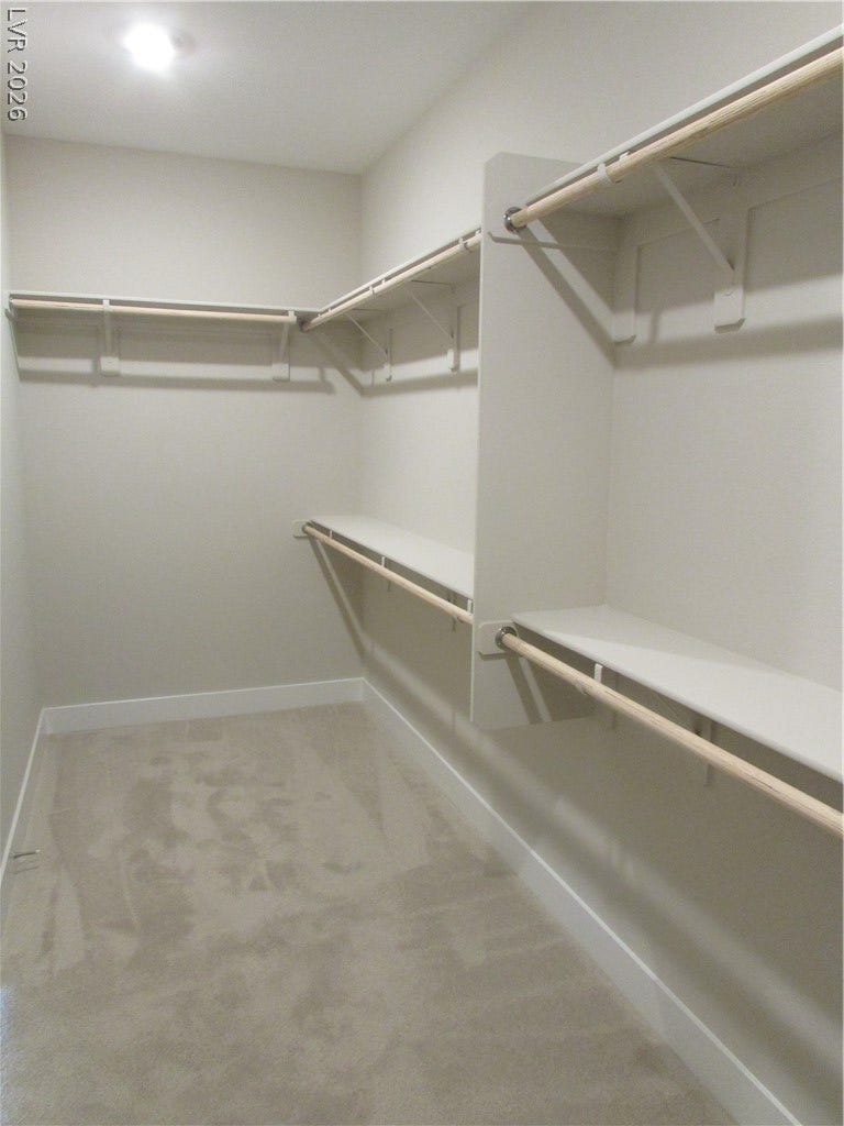 988 Gentle Swan, Henderson, NV 89011 Ample shelving and hanging rods provide versatile storage in this well-appointed closet. Huge Primary Closet! 16' wide! Photo is of actual home.