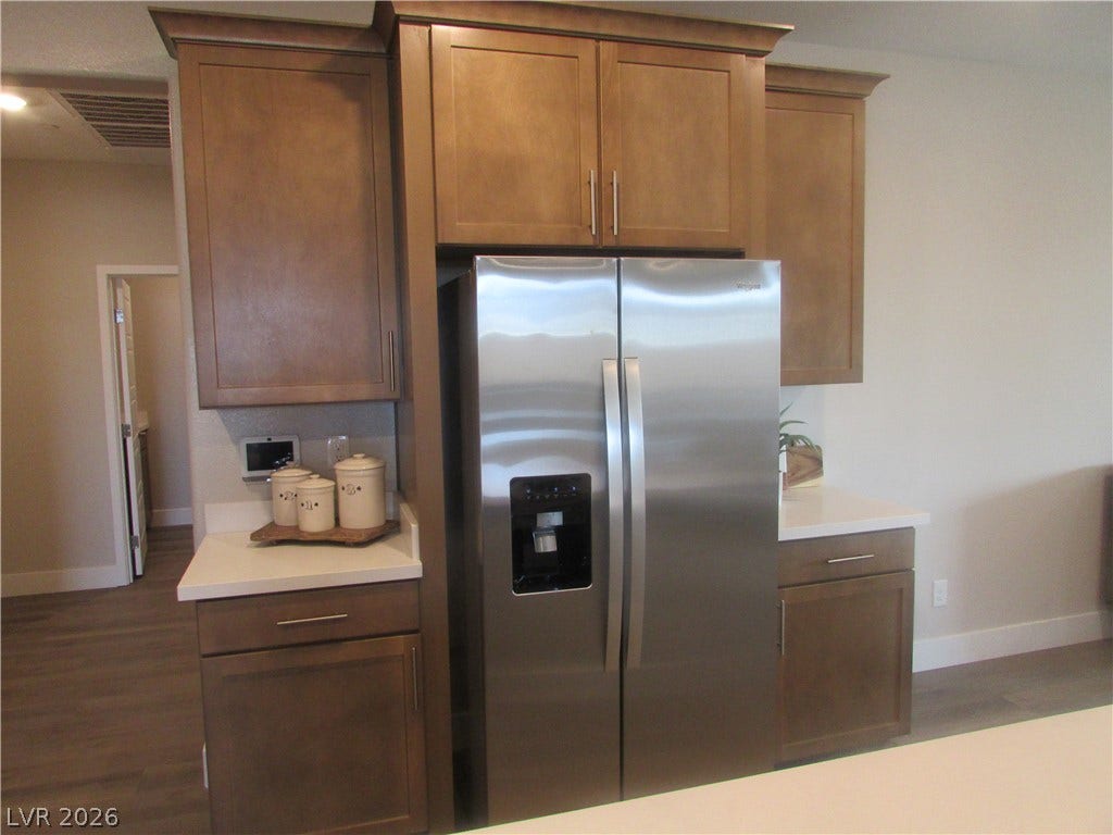 988 Gentle Swan, Henderson, NV 89011 A well-appointed kitchen features rich cabinetry and integrated stainless steel appliances. Fridge included! Photo is of actual home.