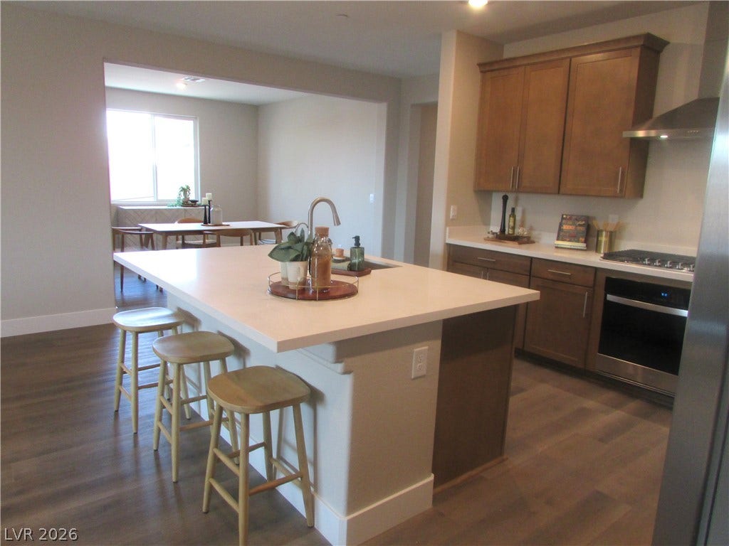 988 Gentle Swan, Henderson, NV 89011 An inviting kitchen with a central island and contemporary appliances flows into a bright dining area. Photo is of actual home.