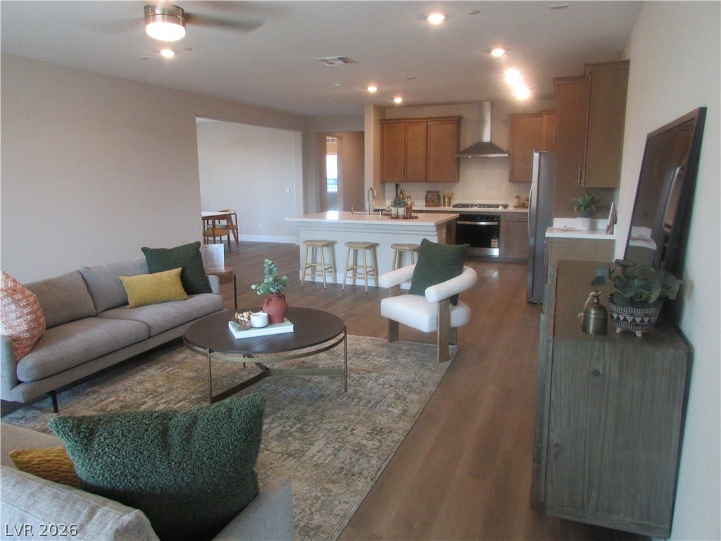 988 Gentle Swan, Henderson, NV 89011 An open-concept living space seamlessly connects to a contemporary kitchen, ideal for entertaining.