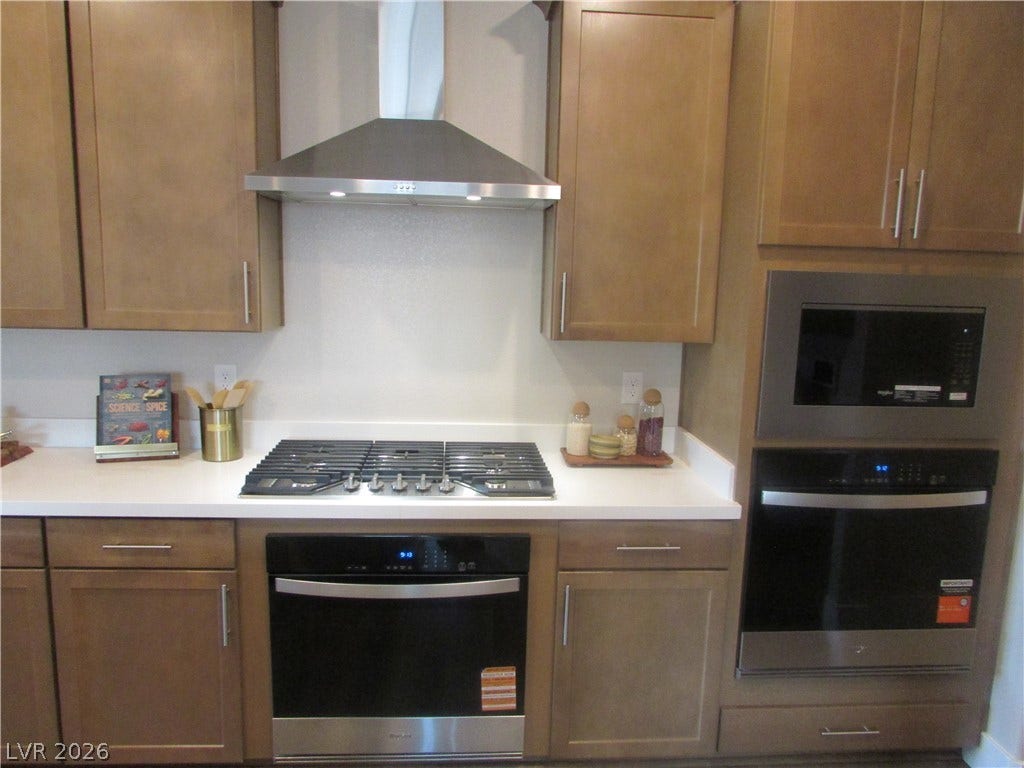 988 Gentle Swan, Henderson, NV 89011 A well-appointed kitchen features a gas cooktop, built-in microwave, and oven for culinary endeavors. Chef's kitchen with Double Ovens and 36" 5 burner cooktop. Photo is of actual home.