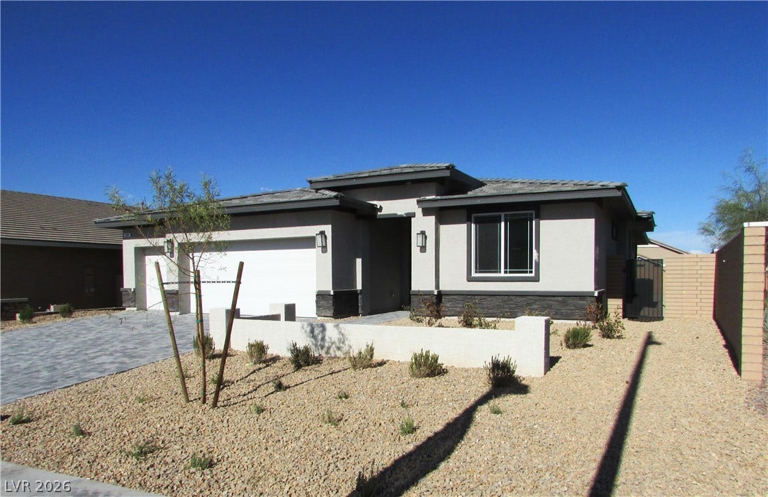 988 Gentle Swan, Henderson, NV 89011 Modern desert home showcases a paver driveway and low-maintenance landscaping.