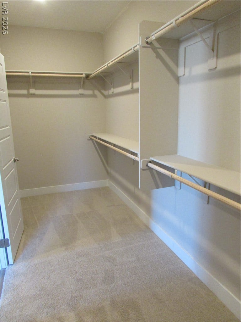988 Gentle Swan, Henderson, NV 89011 Ample shelving and hanging rods create an organized walk-in closet for your wardrobe. Photo is of actual home.